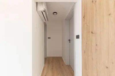 a hallway with white walls and a ceiling at Yellow and Green apartments in Ljubljana