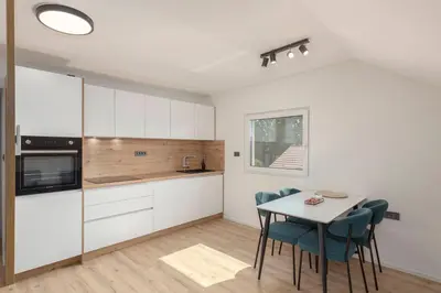 a kitchen and dining room with a table and chairs at Yellow and Green apartments in Ljubljana