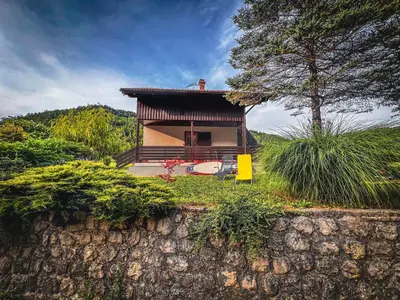 a small house on top of a stone wall at Casa Kolpa in Dragatuš