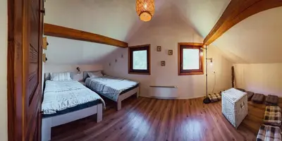 a bedroom with two beds in a attic at Casa Kolpa in Dragatuš