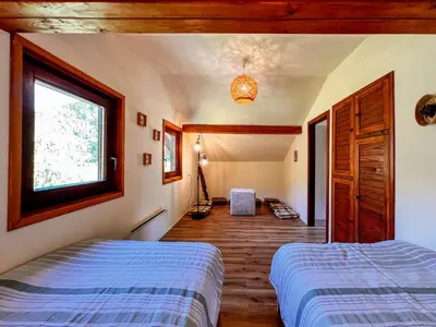 a bedroom with two beds and a window at Casa Kolpa in Dragatuš