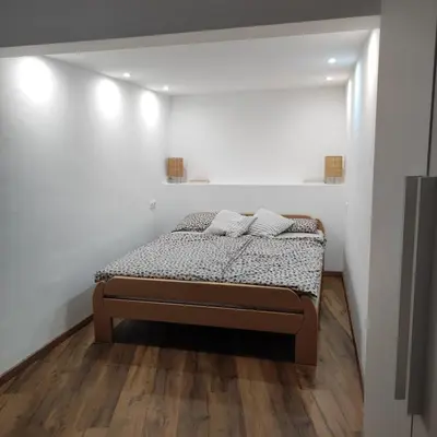a bedroom with a bed with two pillows on it at Elegant City Escape Old Town Ptuj Apartment in Ptuj