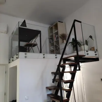a spiral staircase in a room with a white wall at Elegant City Escape Old Town Ptuj Apartment in Ptuj