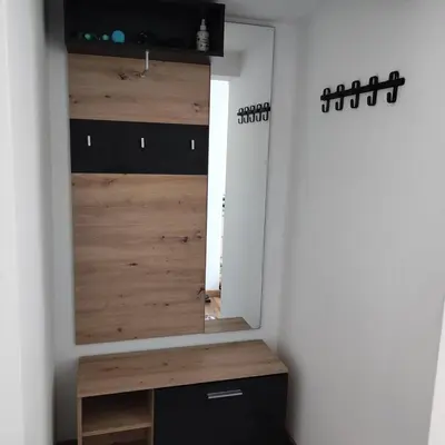 a room with a closet with a wooden door at Elegant City Escape Old Town Ptuj Apartment in Ptuj