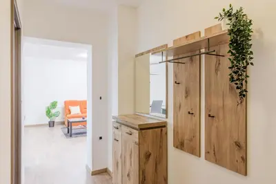 a room with a wooden cabinet and a mirror at Apartmaji Gašperčič, NEJC in Bovec