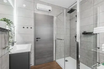 a bathroom with a shower and a sink at Apartmaji Gašperčič, NEJC in Bovec