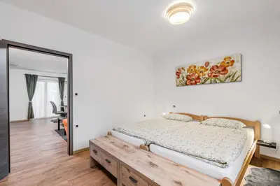 a bedroom with a bed and a mirror at Apartmaji Gašperčič, NEJC in Bovec