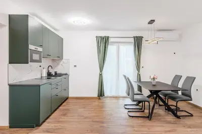 a kitchen with a table and a table and chairs at Apartmaji Gašperčič, NEJC in Bovec