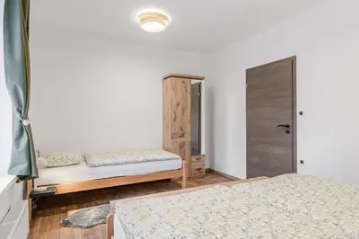 a bedroom with two beds and a closet at Apartmaji Gašperčič, NEJC in Bovec