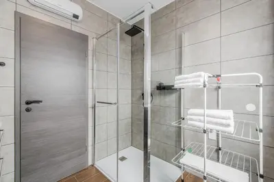 a bathroom with a shower with a glass door at Apartmaji Gašperčič, NEJC in Bovec