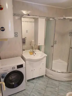 a bathroom with a washing machine and a sink at Apartment old house Koren in Tržič