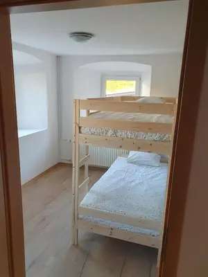 a bedroom with two bunk beds and a window at Apartment old house Koren in Tržič