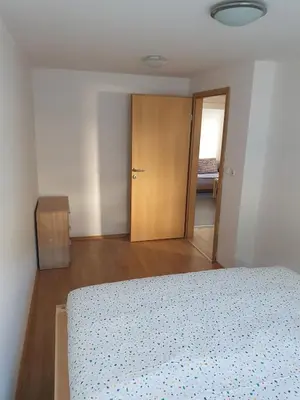 an empty bedroom with a bed and a closet at Apartment old house Koren in Tržič