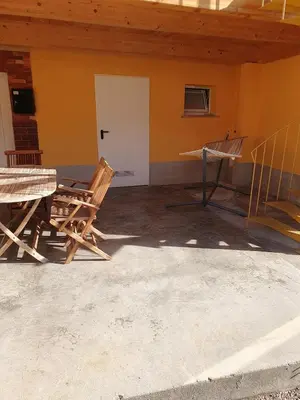 a room with a table and a chair in a building at Apartment old house Koren in Tržič