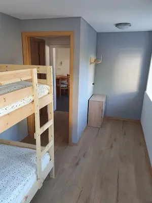 a room with two bunk beds and a dining room at Apartment old house Koren in Tržič