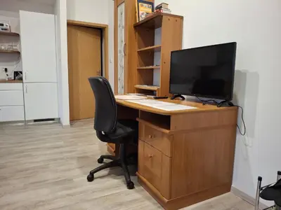 an office with a desk with a television and a chair at Apartma Jasen in Ilirska Bistrica