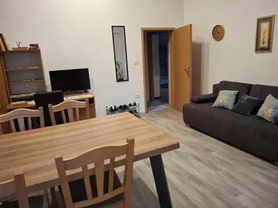 a living room with a table and a couch at Apartma Jasen in Ilirska Bistrica