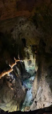 a view of a cave with a river in it at Apartma Jasen in Ilirska Bistrica