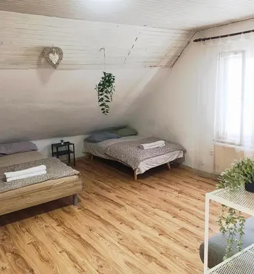 a room with two beds and a wooden floor at Apartment for families or groups in Ljubljana