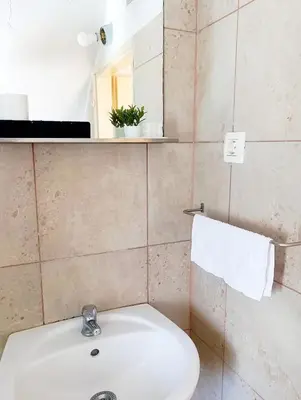 a bathroom with a sink and a toilet and a mirror at Apartment for families or groups in Ljubljana