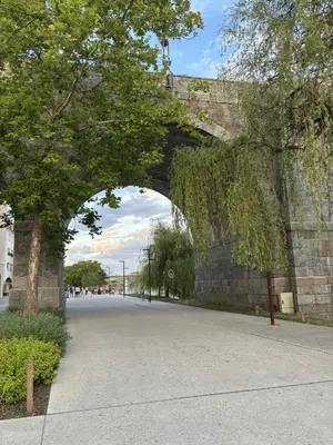 an archway under a stone wall with a road at Studio Lent Riverstay in Maribor