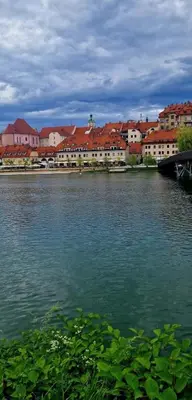a large body of water with buildings in the background at Studio Lent Riverstay in Maribor