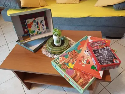 a coffee table with a microwave and books on it at Apartma Zeleni mir in Dobravlje