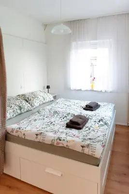 a bed with two towels on it in a bedroom at Apartments Gorishka in Ljubljana