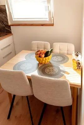 a dining room table with a bowl of fruit on it at Apartments Gorishka in Ljubljana