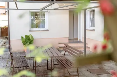 a patio with two benches and a table at Apartments Gorishka in Ljubljana