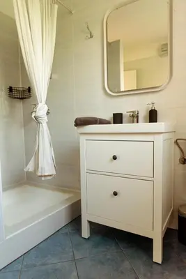 a bathroom with a white sink and a bath tub at Apartments Gorishka in Ljubljana