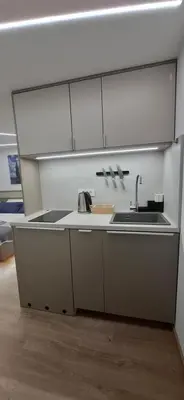 a kitchen with white cabinets and a sink at Studio Suha living in Škofja Loka