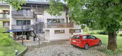 a red car parked in front of a house at Studio Suha living in Škofja Loka