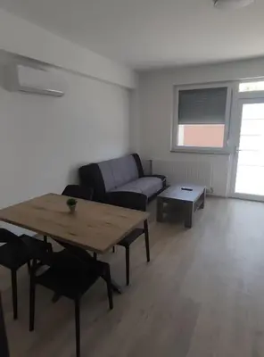 a living room with a table and a couch at Družinski apartmaji Judnič in Adlešiči