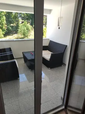 a view of a living room from a glass door at Družinski apartmaji Judnič in Adlešiči