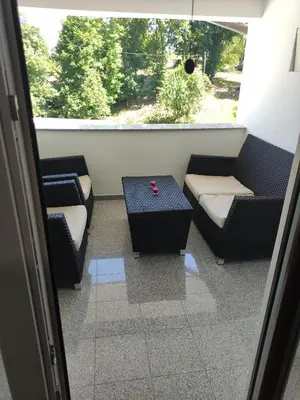 a room with couches and a table and a window at Družinski apartmaji Judnič in Adlešiči