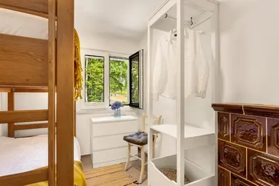 a bedroom with a bunk bed and a closet at Lux House Natura with Sauna & Hot Tub