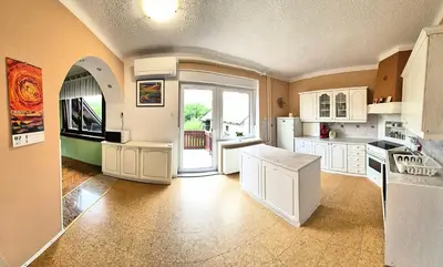 a large kitchen with white cabinets and a large window at Vila Moka near Bled-Entire place with Garden Retreat in Lesce