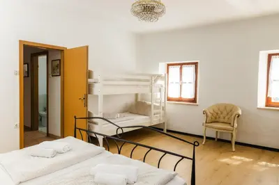 a room with two bunk beds and a chair at Apartment Valetovi in Štanjel