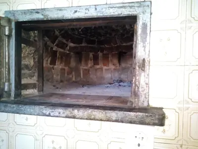 a fireplace in the wall of a room at Apartment Valetovi in Štanjel