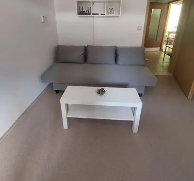 a living room with a couch and a white coffee table at Pr DOLENC in Petrovče