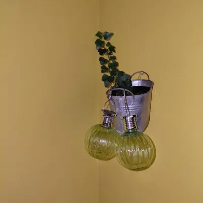 a potted plant in a pot hanging on a wall at Pr DOLENC in Petrovče