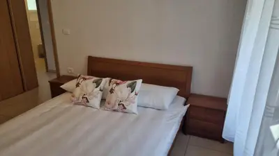 a bed with two pillows on top of it at Apartma Danica in Kobarid