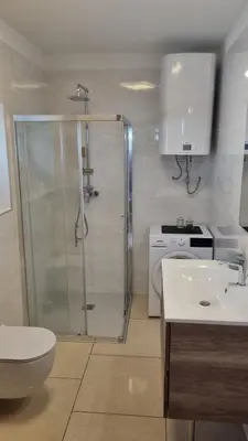 a bathroom with a shower and a toilet and a sink at Apartma Danica in Kobarid