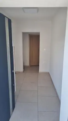 an empty room with a hallway with a door at Apartma Danica in Kobarid