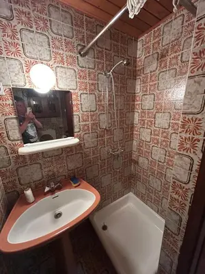a bathroom with a sink and a mirror and a tub at Hiša p'r Kobalu- in Idrija