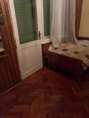 a bedroom with a bed and a window and a door at Hiša p'r Kobalu- in Idrija