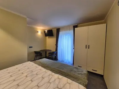 a hotel room with a bed and a table at Mega Apartmaji in Rogaška Slatina