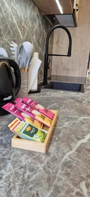 a pile of books sitting on top of a kitchen counter at Mega Apartmaji in Rogaška Slatina