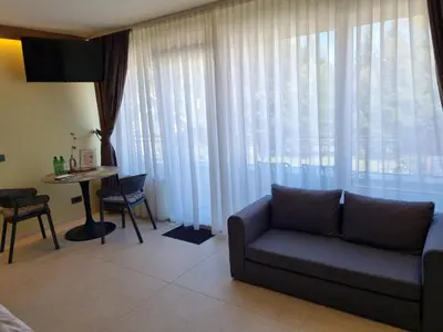 a living room with a couch and a table at Mega Apartmaji in Rogaška Slatina